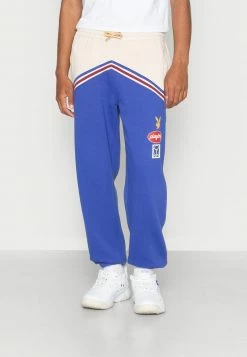 Mennace PLAYBOY BADGE PANEL REGULAR JOGGER UNISEX - Jogginghose - Blue